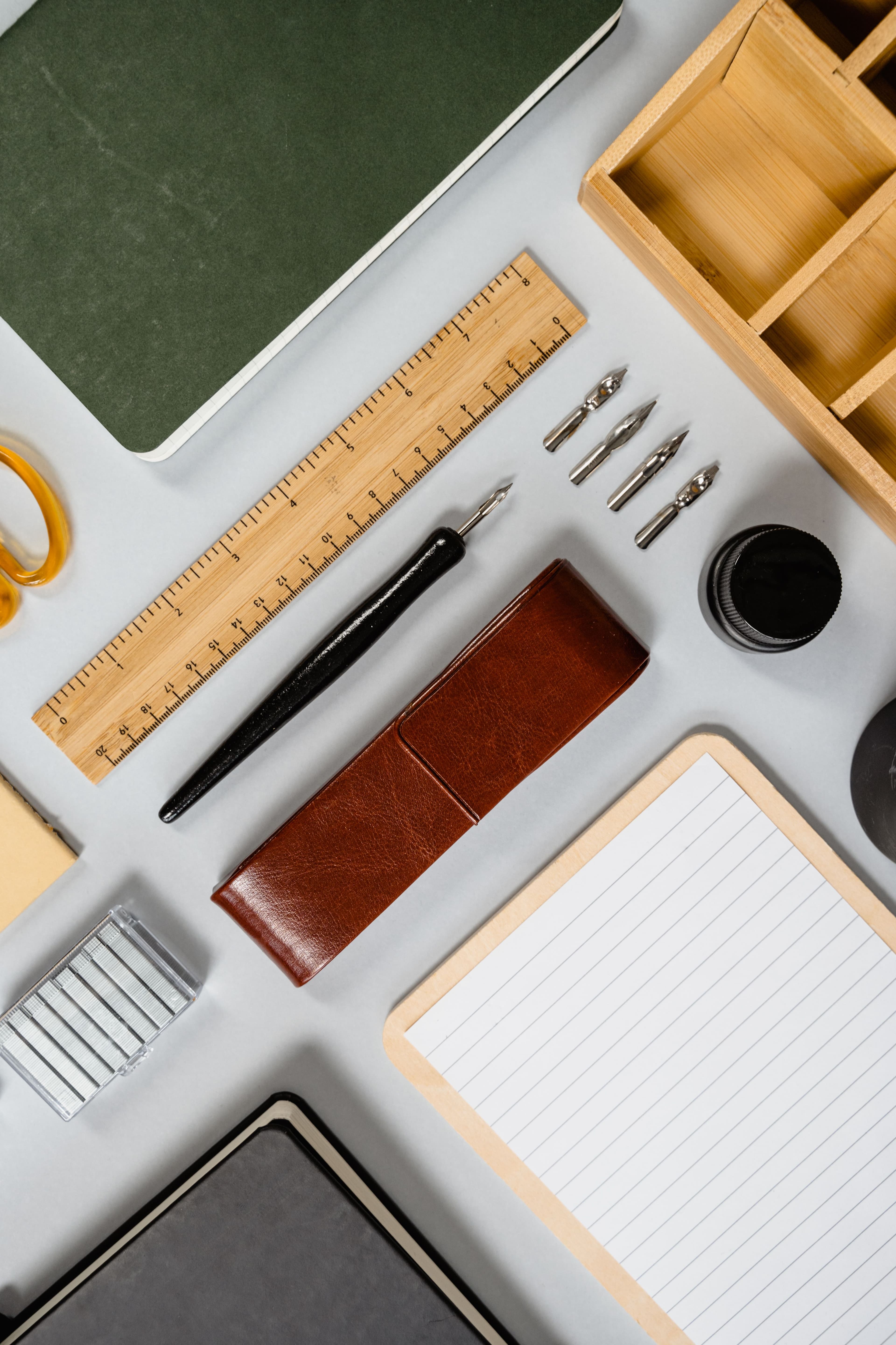 Open notebook, pens and colour swatches on a studio desk