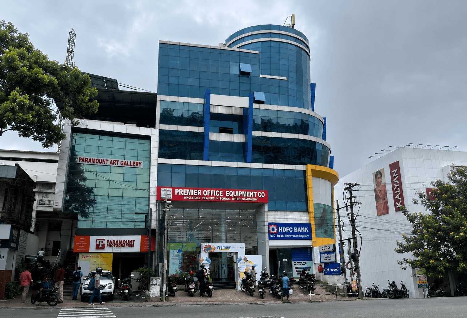 Premier storefront on MG Road with a glass facade and warm interior lighting